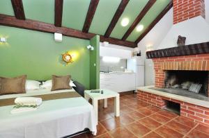 a room with two beds and a fireplace at House Sweet Dreams in Pučišća