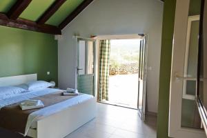a bedroom with a bed and a sliding glass door at House Sweet Dreams in Pučišća +37 photos