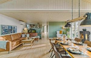 a living room with a couch and a table at 3 Bedroom Cozy Home In Nibe in Nibe
