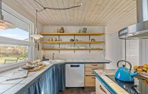 a kitchen with a white refrigerator and a counter at 3 Bedroom Cozy Home In Nibe in Nibe +20 photos