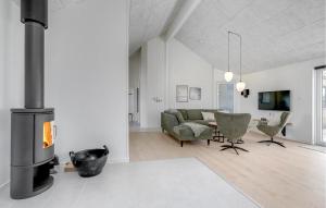a living room with a couch and a fireplace at Nice Home In Nørre Nebel With Sauna in Nørre Nebel