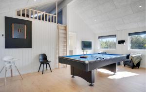 a ping pong table in a room with a bill at Lovely Home In Vejers Strand With Sauna in Vejers Strand