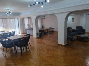a living room with a table and chairs at Pyramids Nights Hostel in Cairo