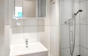 a white bathroom with a sink and a shower at Ferienwohnung Pruchten in Pruchten