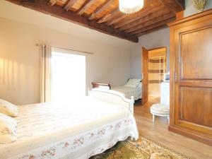 a bedroom with a bed and a large window at Maison historique avec chambres d'hôtes et parc clos à Choye - FR-1-583-293 in Choye