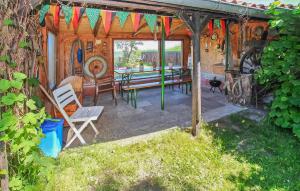 a wooden shed with a picnic table and a bench at Ferienhaus Ueckermünde Bellin in Bellin