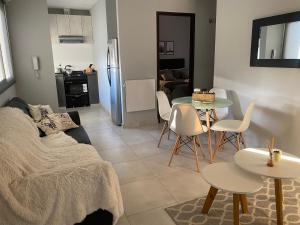 a living room with a couch and a table and chairs at Micro ensueño in Godoy Cruz +10 photos