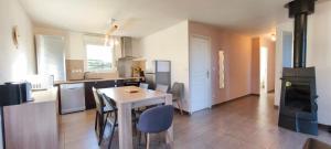 a kitchen with a wooden table and a stove at Maison plain-pied Calme et Nature in Cuvier +10 photos