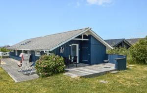 a blue shed with a porch and a deck at Holiday Home Lakolk Iv Denmark in Bolilmark
