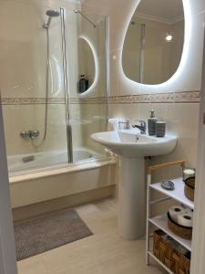a bathroom with a sink and a shower at Ático playa Palmás in Moaña +36 photos