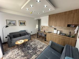 a living room with a couch and a table at Gencian resort in Kopaonik
