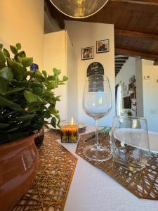 a table with a candle and a wine glass at Pantheon Gabbianina Home in Rome +64 photos