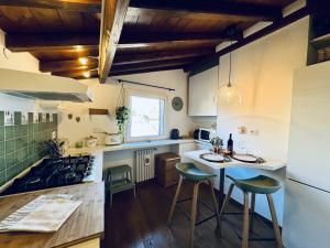 a kitchen with a table and a stove top oven at Pantheon Gabbianina Home in Rome