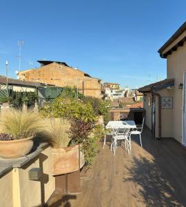 a patio with a table and chairs on a balcony at Pantheon Gabbianina Home in Rome