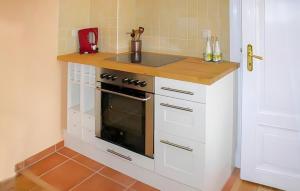 a kitchen with a stove and a counter top at Ferienwohnung Bad Doberan in Bad Doberan