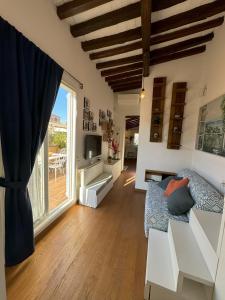 a living room with a couch and a large window at Pantheon Gabbianina Home in Rome