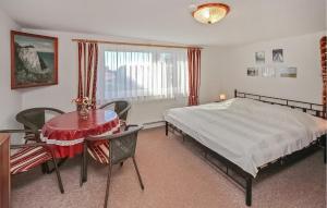a bedroom with a bed and a table and chairs at Ferienwohnung Patzig Auf Rügen in Patzig