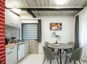 a kitchen and dining room with a table and chairs at Edison,Plitvice Lakes in Jezerce