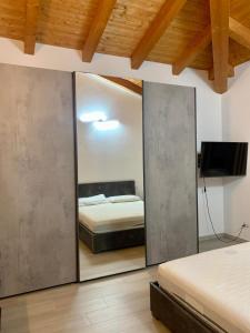 a bedroom with a mirror and a bed in it at Casa di Barbara in Piumazzo +20 photos