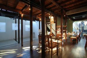 a dining room with tables and chairs and windows at hanare in Tokyo