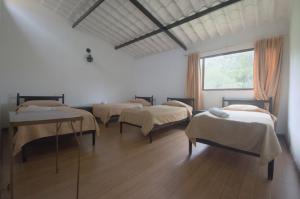 Postel nebo postele na pokoji v ubytování Tacuara Hotel