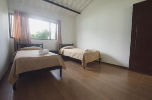 Postel nebo postele na pokoji v ubytování Tacuara Hotel