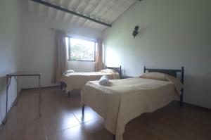Postel nebo postele na pokoji v ubytování Tacuara Hotel