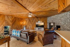 a living room with a couch and a table at Hot Tub and Spacious Backyard Close to Lake! in Coeur d'Alene