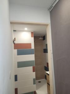 a hallway with a colorful wall in a room at Le studio 29 in Le Barcarès