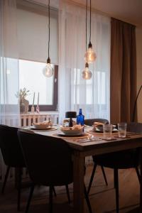 a dining room table with plates of food on it at Gemütliche & Moderne Wohnung -Altstadt -Bielefeld in Bielefeld