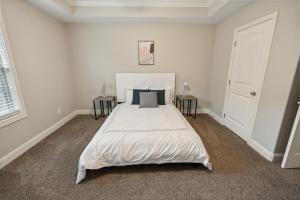 a bedroom with a large white bed with two tables at Biltmore Luxury 1513 #5 Townhomes L 2bd 2 Bth in Clarksville