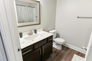 a bathroom with a sink and a toilet and a mirror at Biltmore Luxury 1513 #8 Townhomes L 2bd 2 Bth in Clarksville +16 photos
