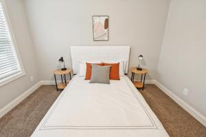 a white bed in a room with two side tables at Biltmore Luxury 1517 #6 Townhomes L 2bd 2 Bth in Clarksville