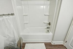 a white bathroom with a tub and a shower at Biltmore Luxury 1517 #6 Townhomes L 2bd 2 Bth in Clarksville +15 photos