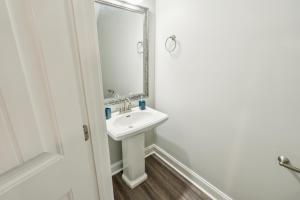 a bathroom with a sink and a mirror at Biltmore Luxury 1517 #2 Townhomes L 2bd 2 Bth in Clarksville +16 photos