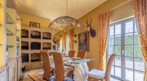 a dining room with a table and chairs and a chandelier at Countryhouse Blauw in De Panne