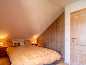 a bedroom with a large bed with a wooden headboard at Countryhouse Blauw in De Panne +7 photos