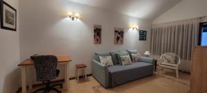 a living room with a couch and a table and a desk at Sabbia Suites Marazul in Playa Honda