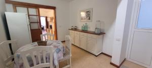 a kitchen with a table and two chairs in a room at Sabbia Suites Marazul in Playa Honda +5 photos