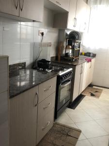 a kitchen with a stove and a counter top at Rura Homes in Kiambu