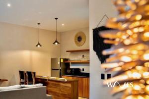 a room with a kitchen and a living room at Natural Lighted Boho Chic Studio with Private Pool by Waves in Tulum +15 photos