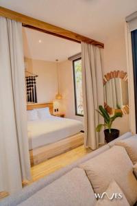 a bedroom with a bed and a large mirror at Natural Lighted Boho Chic Studio with Private Pool by Waves in Tulum
