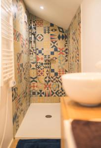 a bathroom with a sink and mosaic tiles on the wall at Patio - 2min gare - Local velos motos - clim in Bordeaux +6 photos