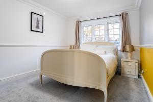 a white bed in a room with a window at Purley House-Sleeps 8-Near Gatwick-Games Room in Purley