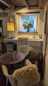 a kitchen with a table and a sink and a window at The Hideaway in Falmouth