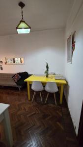 a yellow table and two chairs in a room at Mi Hogar tu Hogar in Salta +9 photos