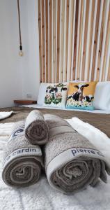 a bed with a pile of towels on it at Azure Loft 2 in Mosteiros