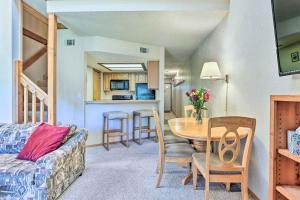 a living room with a table and a kitchen at Mountainside Royalview Condo: Pool/Hot Tubs, Great Location in Frisco