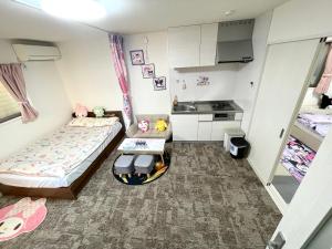 Postel nebo postele na pokoji v ubytování 糖果屋 岸里玉出
