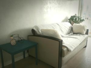 a bed with white sheets and a table in a room at Eiffel Tower spacious 2-bedroom, 2-bathroom quiet apartment, elegant and peaceful in Paris